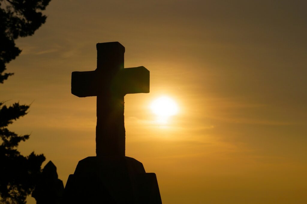 A cross in the sunset. What happens during the month of May
